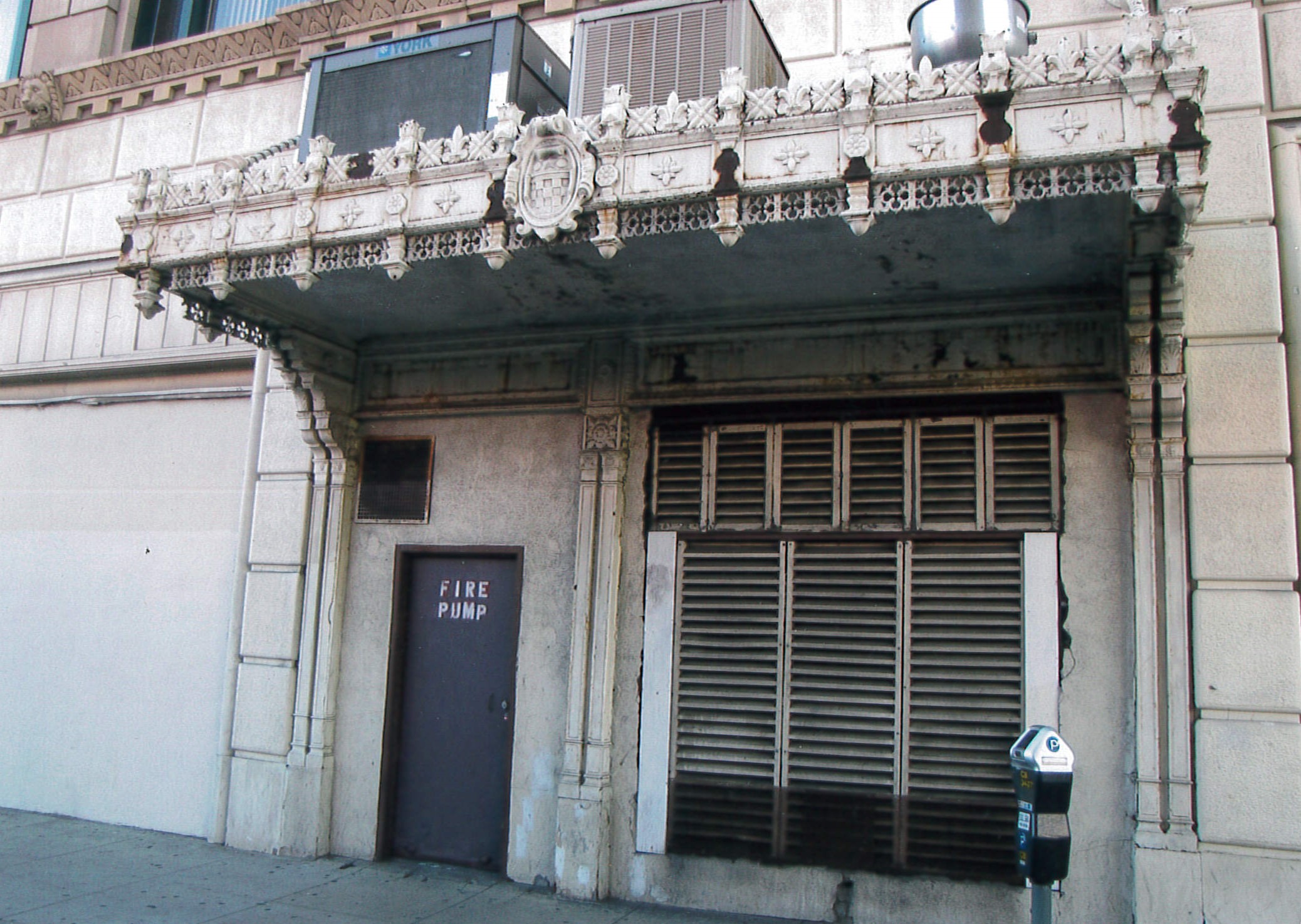 Secondary entryway with cast iron marquee
